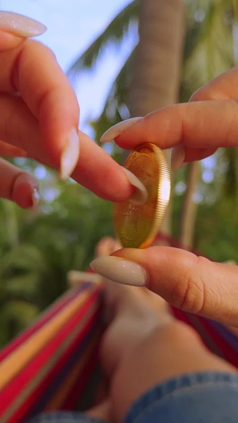 Vertical video. First Person View Holding Golden Tether Coin With Both Hands Abo Stock Footage 326971811