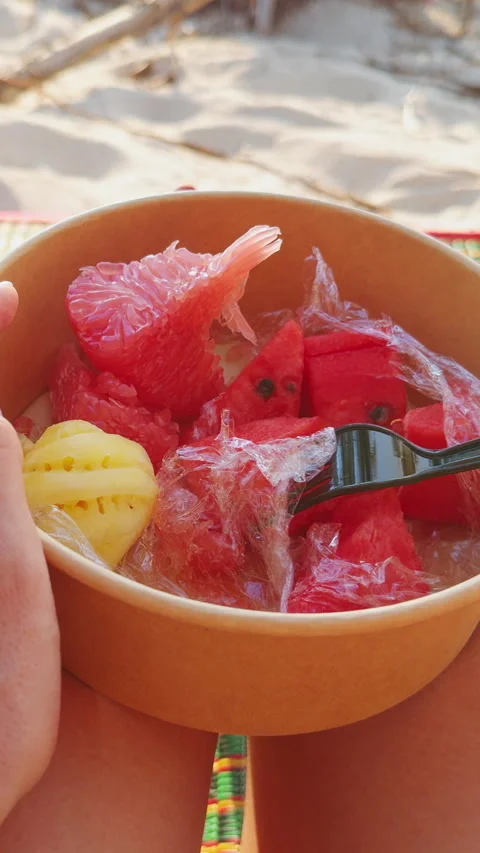Vertical video. First Person View Of Hand Picking Mini Pineapple Piece From Bowl Stock Footage 332295851