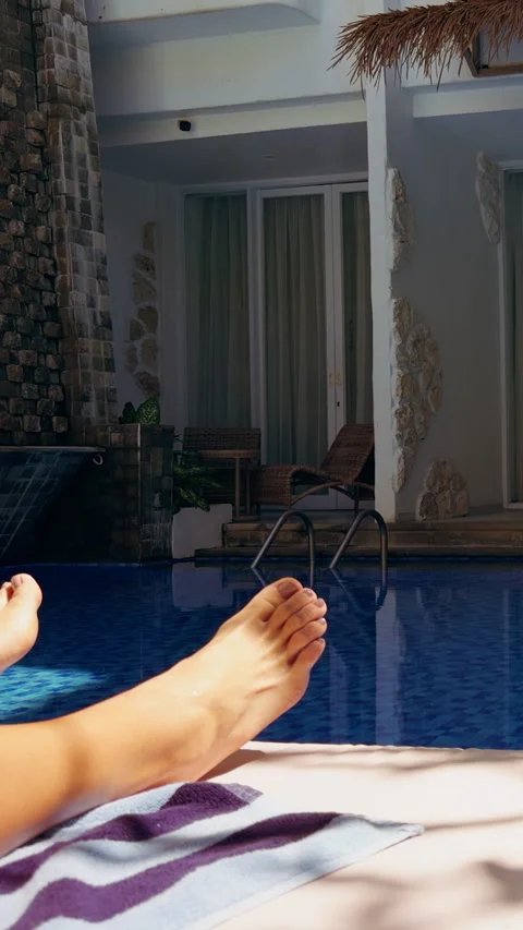 Vertical video. First Person View Of Resort Swimming Pool And Modern Hotel Build Video stock 337025293