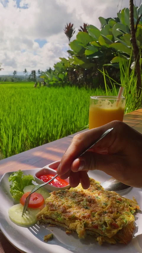 Vertical video. First Person View Holding Fresh Cucumber Slice Above Breakfast P Stock Footage 337031838