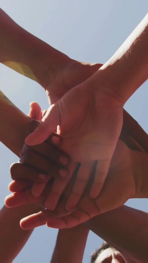 Vertical video: Five men stacking hands, animating finance charts above palms, Stock Footage 331790043