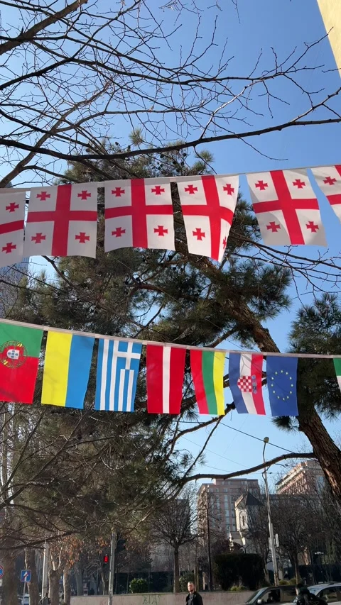Vertical video. Flags of different European countries on rope in street Stock Footage 232045569