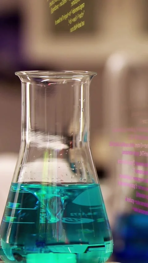 Vertical video: Flask on bench forming vortex when code overlays drifting in, Stock Footage 330655699