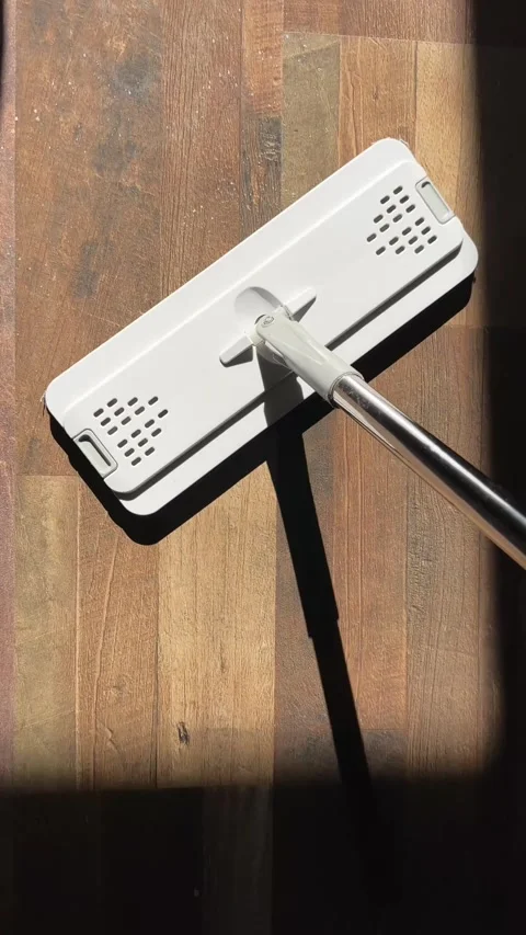 Vertical video of a flat microfiber mop cleaning a wooden floor with visible Stock Footage 317752722