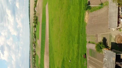 Vertical video. Flight over a field with cattle and country streets. Stock Footage 234220976