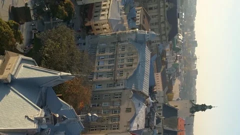 Vertical video. Flight over the old historical part of the city of Lviv. Video stock 234192787