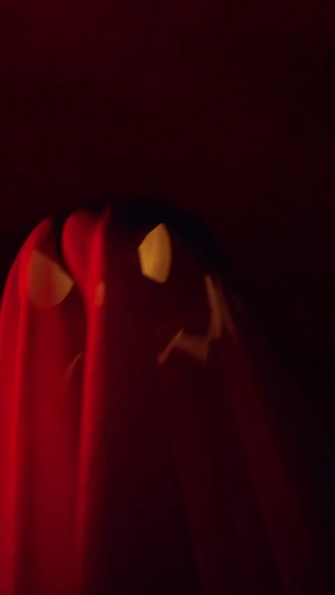 Vertical video. Floating Ghost Shaped Jack O Lantern Against Dark Tunnel Backgro Stock Footage 337104250