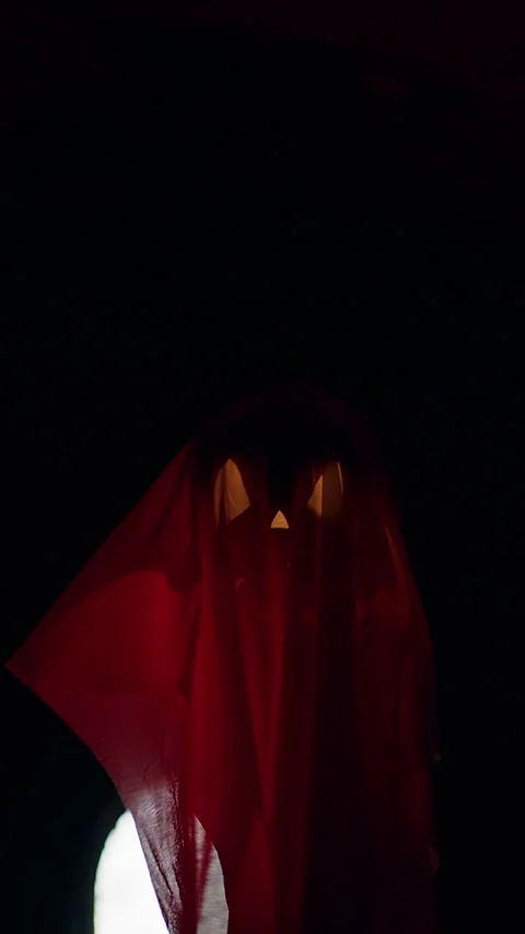 Vertical video. Floating Ghost Shaped Jack O Lantern in Dark Tunnel With Red Lig Stock Footage 337106457