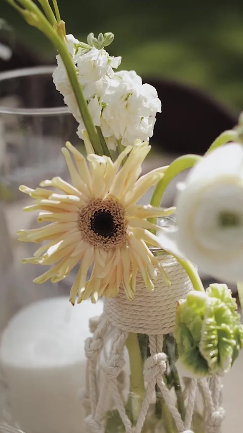 Vertical video. Flower in a vase on the table close-up. Floral table setting Stock-Footage 308720231