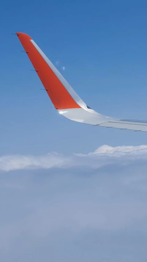 Vertical video  from the flying airplane window on cumulus clouds and wing. Video stock 337211549