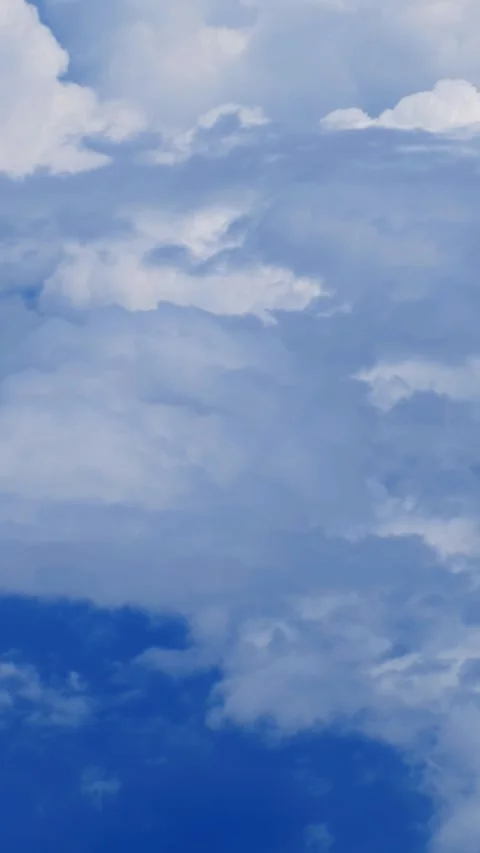 Vertical video from the flying airplane window on cumulus clouds Stock Footage 337211594