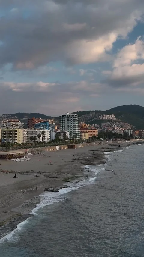 Vertical Video: Foamy Waves Rolling Over a Rocky Beach Creating Stunning Sea Stock Footage 297715951