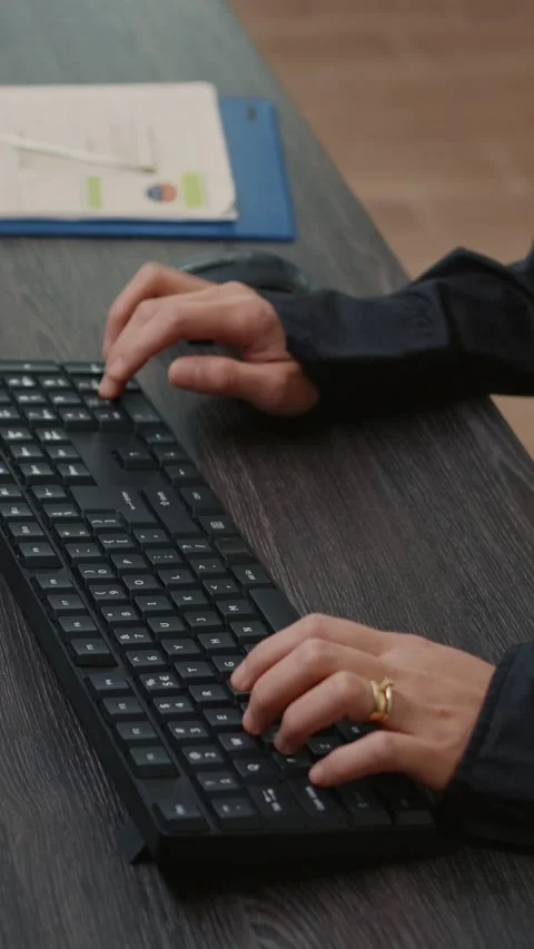 Vertical video Focus on programer hands typing code on keyboard while looking at Stock Footage 201718059