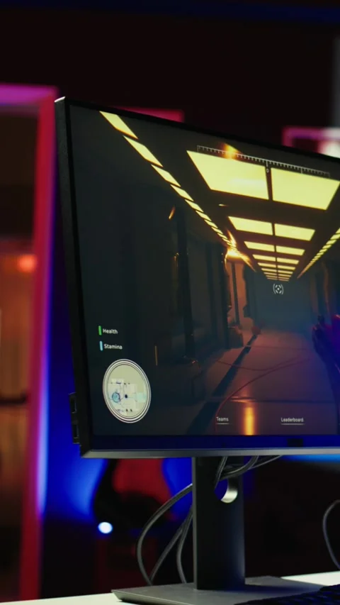 Vertical video FPS videogame left open on pc display and computer peripherals in Stock Footage 282796113