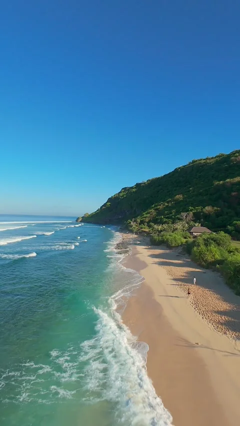 Vertical video. FPV Drone Chasing Ocean Swell at Nyang Nyang Beach, High Speed F Stock Footage 336638359