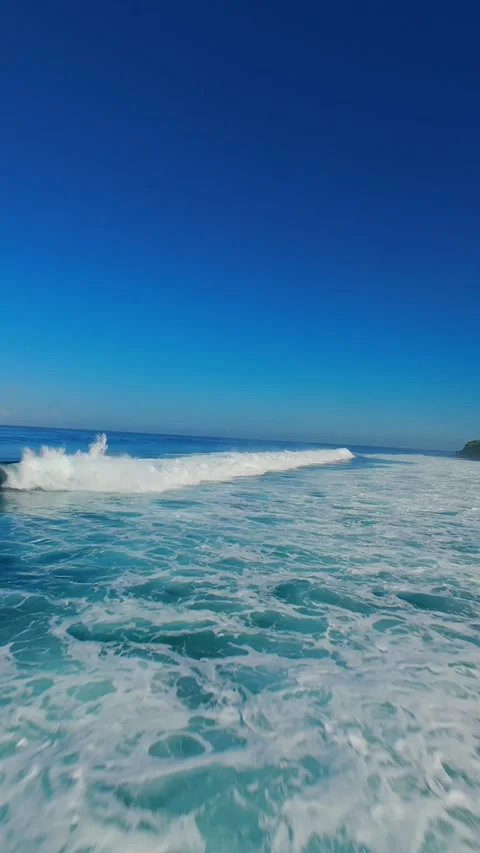 Vertical video. FPV Drone Chasing Breaking Wave at Nyang Nyang Beach, High Speed Stock Footage 336639294