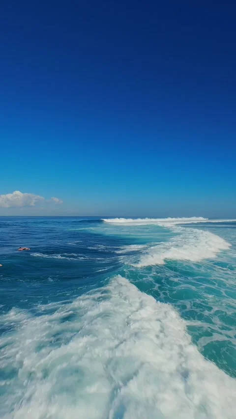 Vertical video. FPV Drone Chasing Ocean Wave With Surfers at Nyang Nyang Beach, Stock Footage 336639456