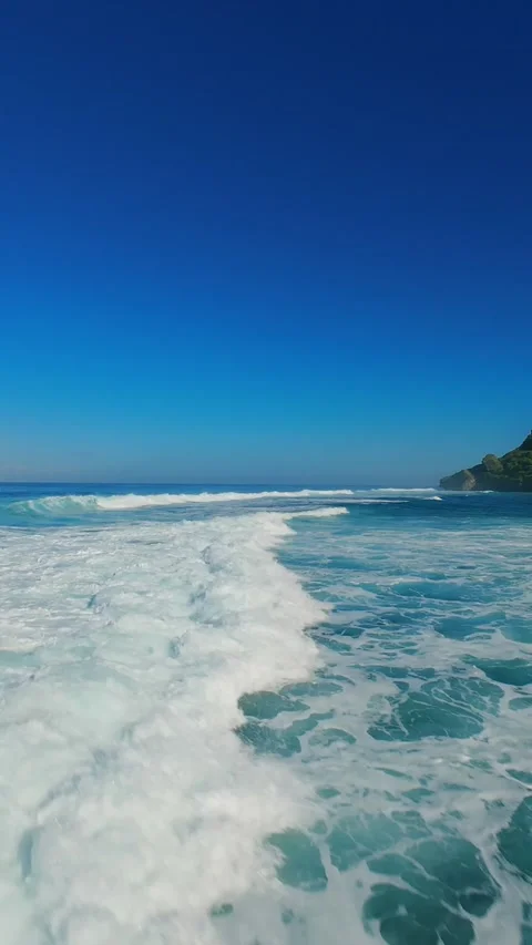 Vertical video. FPV Drone Chasing Breaking Ocean Waves at Nyang Nyang Beach, Hig Stock Footage 336639526
