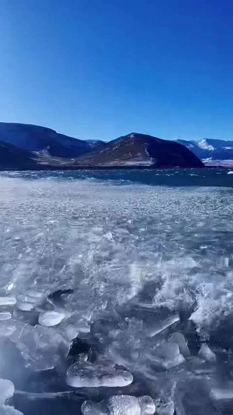 Vertical video of fragmented drift ice shards crashing and piling up on shor Stock Footage 327689501