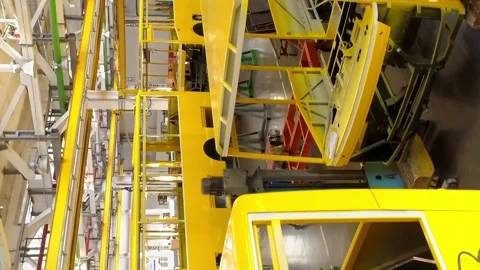 Vertical video. Frames of bus on the conveyor line of the plant for the Stock-Footage 250414317
