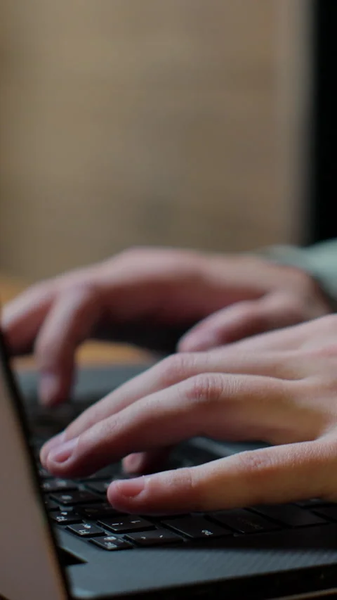 Vertical video. Freelancer's hands typing on laptop keyboard. Stock Footage 345235423