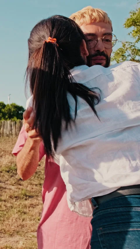 Vertical video, Friends Hugging and Enjoying a Sunny Picnic Stock Footage 312184840