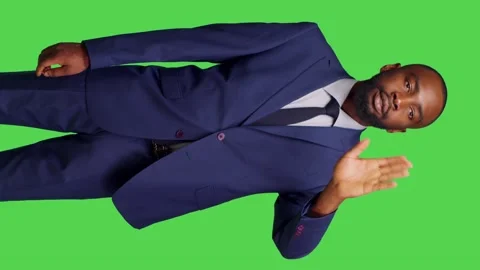 Vertical video: Front side of young businessman waving at someone in studio Stock Footage 237282700