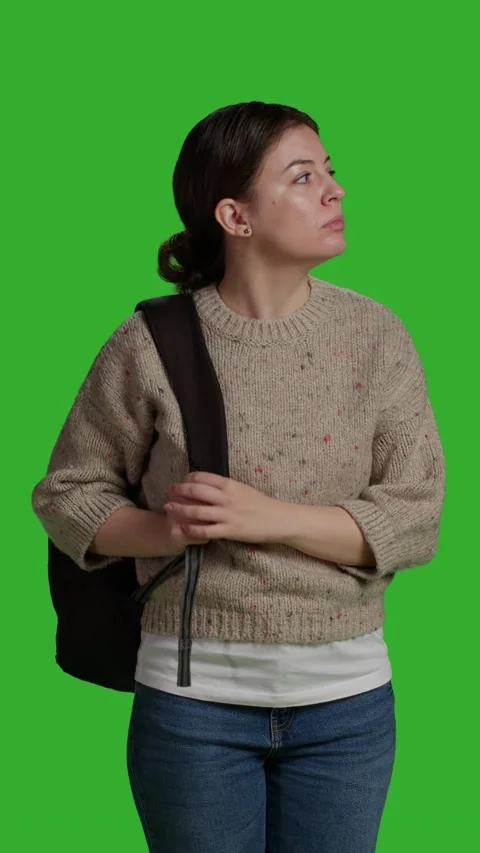 Vertical video: Front view of close up female model carrying backpack Stock Footage 224742791