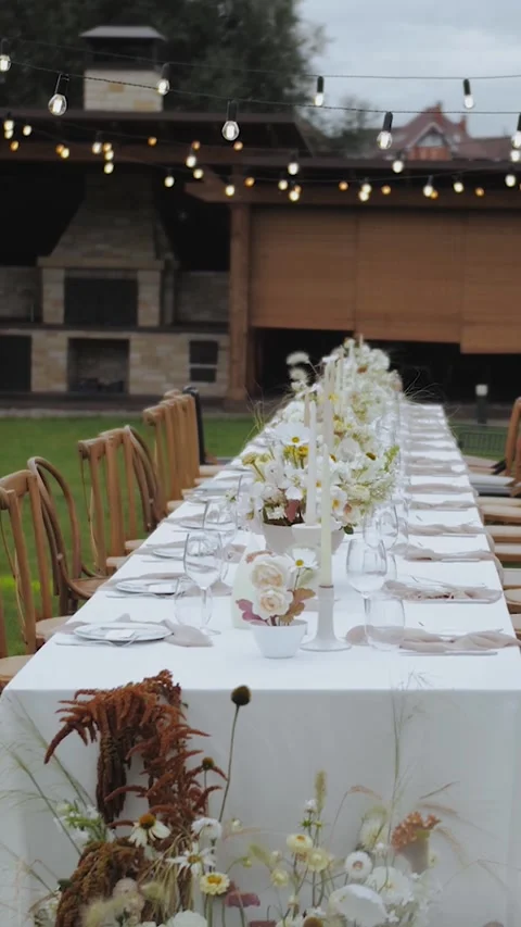 Vertical video. Front view of a festively decorated dining table at a wedding or Stock Footage 322526800