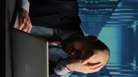 Vertical video: Frustrated database admin making mistake in data center Stock Footage 234018533