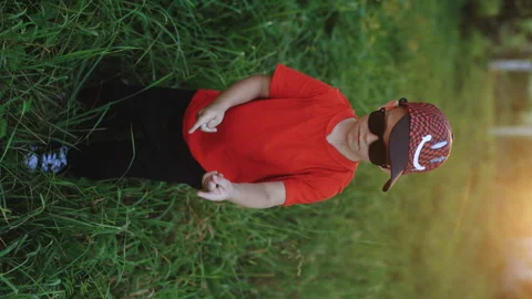 Vertical video of funny boy posing dancing at sunset having fun and positive Stock Footage 248209592