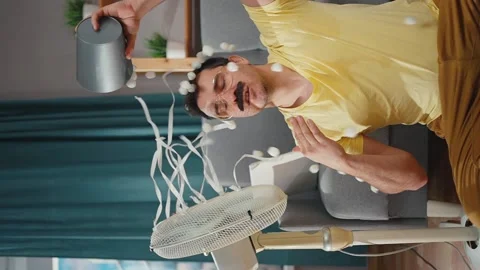 Vertical video a funny man with a mustache suffers from the heat knocks over a Stock Footage 225092673