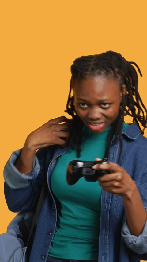 Vertical video Gamer holds controller, focused on finishing videogame level Stock Footage 274234611
