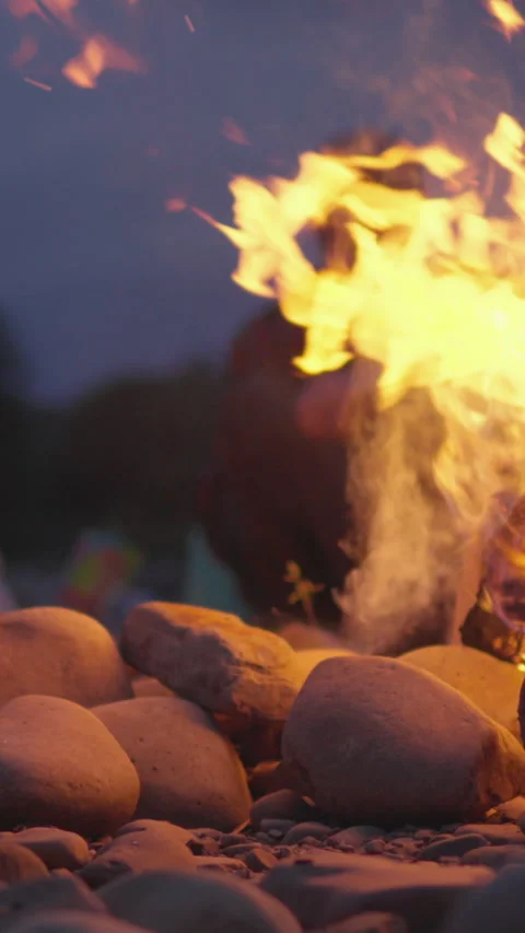 Vertical video gather around a campfire with friends on a peaceful evening Stock Footage 277908295