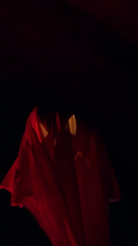 Vertical video. Ghost Like Jack O Lantern Drifting Through Dark Tunnel With Red Stock Footage 337106609