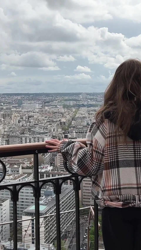 Vertical video girl on a eiffel tower looks around at the city of Paris visible Stock Footage 244255508