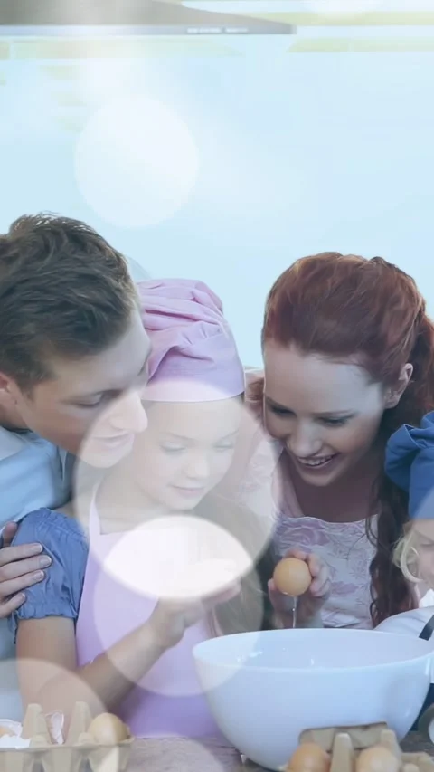 Vertical video: Girl tapping egg with parents guiding, cracking into white bowl, Stock Footage 334046966