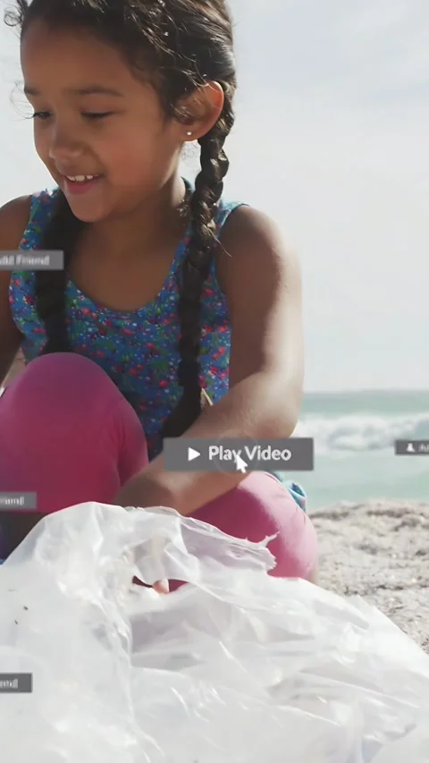 Vertical video: Girl tapping Play picking plastic to clean beach while man Stock Footage 334046888