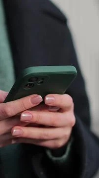 Vertical video Girl using texting mobile phone or chat. Close up of woman han Stock Photos