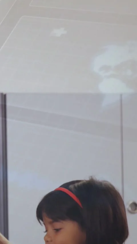 Vertical video: Globe projecting above, girl red band leaning at peer and Stock Footage 334398216
