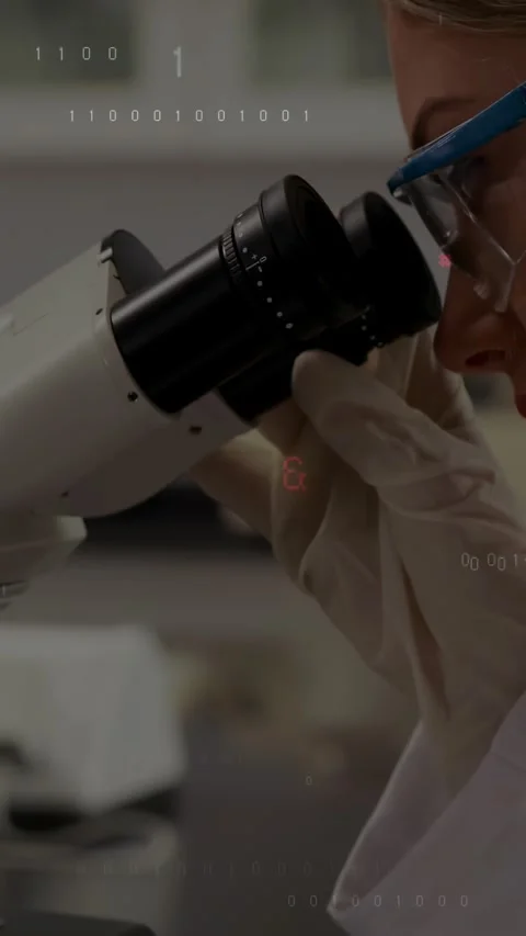 Vertical video: Gloved hand turning ocular, lab tech peering into scope, code Stock Footage 334317199
