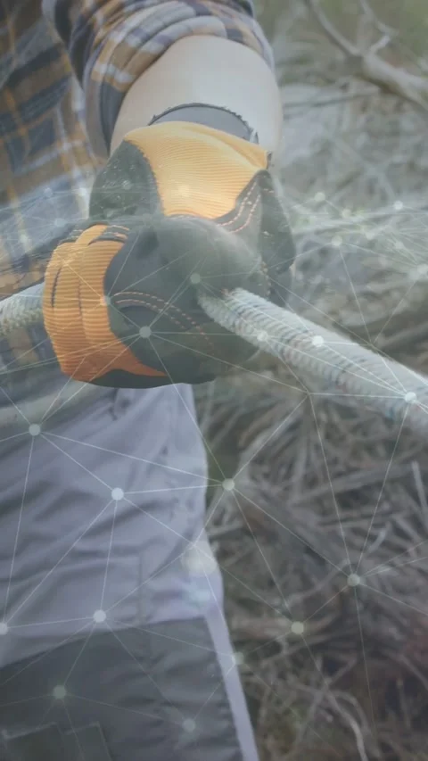 Vertical video: Gloved hands holding looped rope, pulling and tightening strand Stock Footage 337540881
