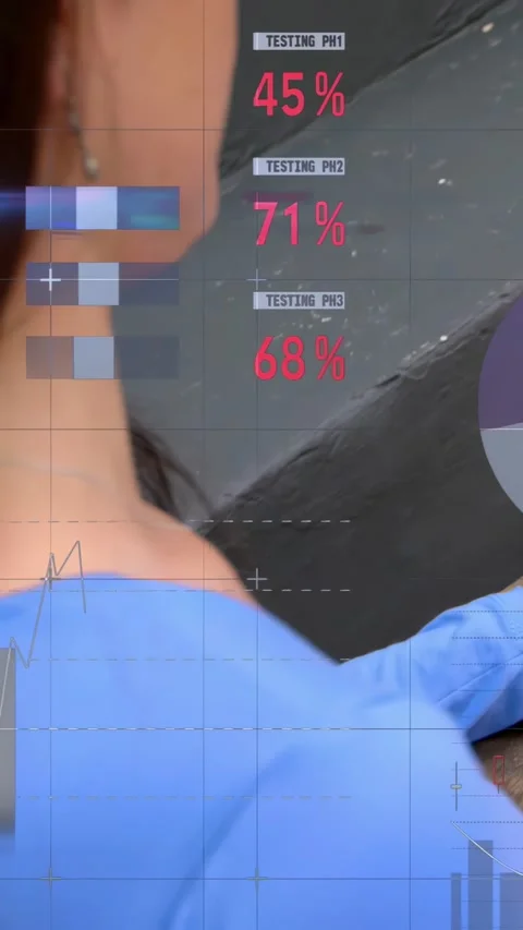 Vertical video: Gloved male tech rotating device and animating HUD, showing lab Stock Footage 334598950
