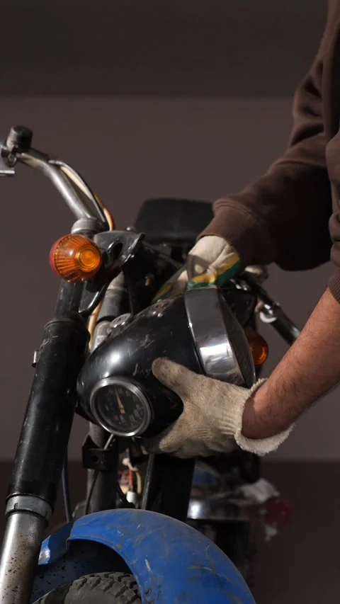 Vertical video gloved mechanic hand working on the headlight and dashboard of Stock Footage 340430364