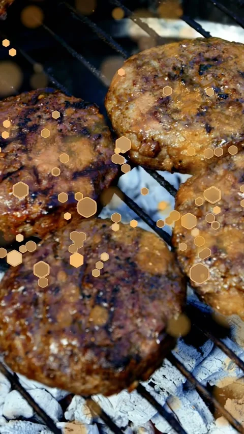 Vertical video: Glowing coals starting four patties searing, fat pooling, pepper Stock Footage 334770599