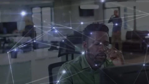 Vertical video: Glowing nodes driving office worker in green shirt from thinking Stock Footage 333318274