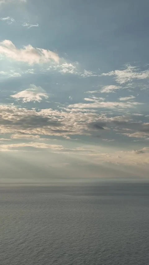 Vertical Video: Glowing Sunset Over the Mediterranean Coast with Gentle Waves Stock Footage 297714547