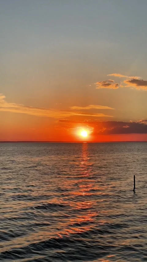 Vertical Video of Golden Sunset Over Calm Ocean Waves Stock-Footage 337674892