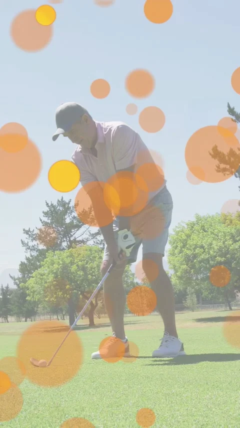 Vertical video: Golfer adjusting grip starting swing hitting target orange bokeh Stock Footage 333862066