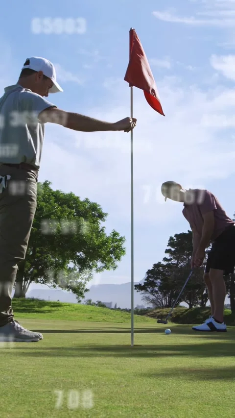 Vertical video: Golfer lining up, stroking putt to score, flag-holder, numbers Stock Footage 333079581